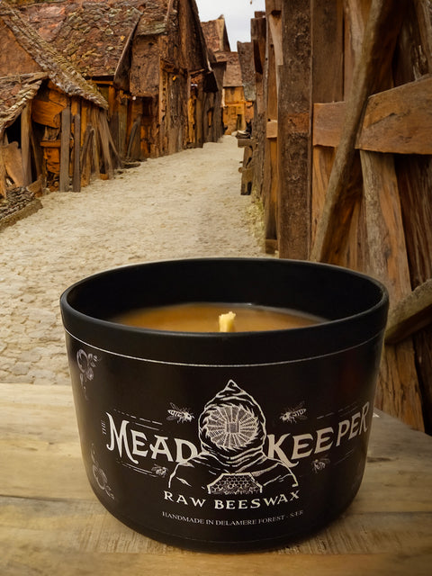 Product photo of real mead keeper candle with wax and wick on show - background is AI. 